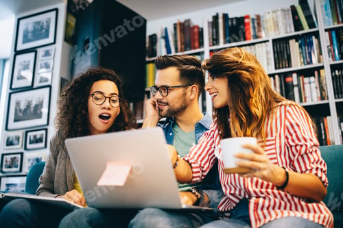 Preview: Group of happy students reading books and preparing to exam in library