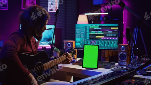 Preview: Male artist learning to play guitar on online lesson tutorial