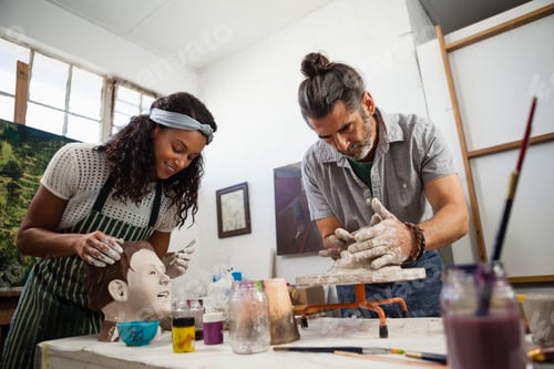 Preview: Woman and man learning pottery in class