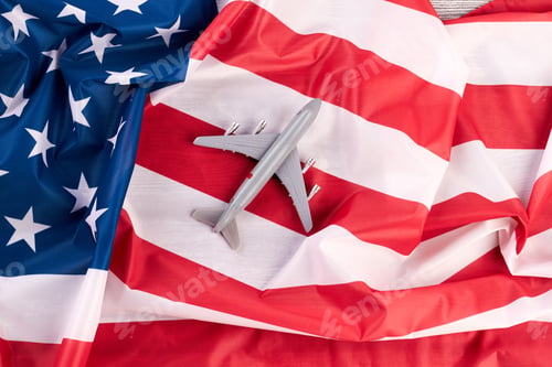 Preview: American flag and plastic toy air plane.