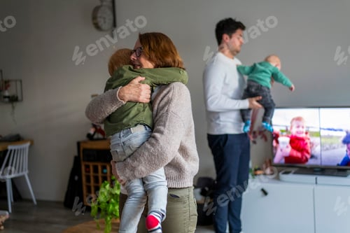 Preview: Family time at home with parents hugging their children