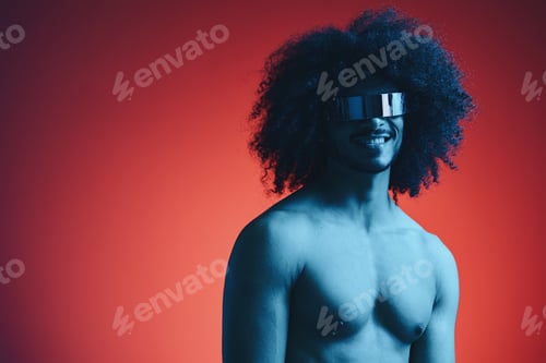 Preview: Portrait of fashion man with curly hair on red background with stylish glasses, multinational