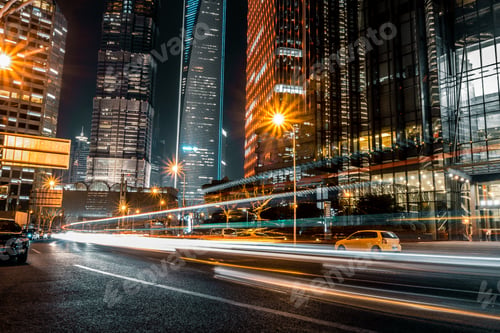 Illuminated Cityscape at Night with Car Light Streaks