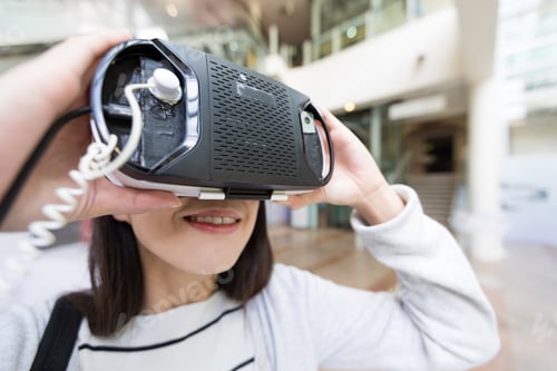 Preview: Woman trying on vr device in museum