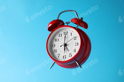 Preview: Red alarm clock in air on light blue background