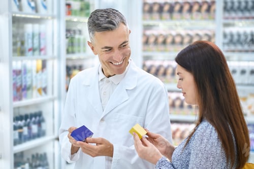 Preview: Male pharmacist consulting a customer in a drugstore