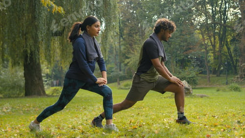 Preview: Confident determined Indian couple Arabian man woman girl guy doing lunges squats exercises sport