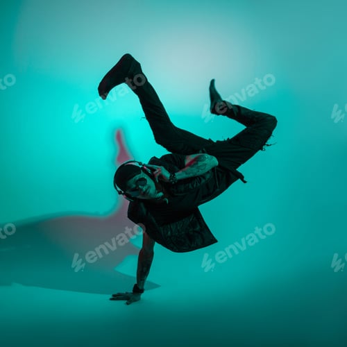 Preview: Handsome stylish dancer cool man in fashionable clothes dancing in colorful studio