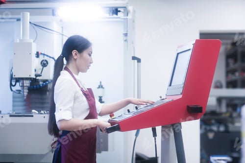 Preview: A focused technician operating advanced machinery in a lab setting