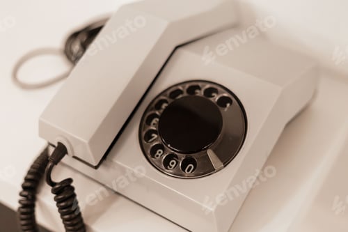 Preview: This vintage rotary telephone is placed on a clean, smooth surface, highlighting its unique design