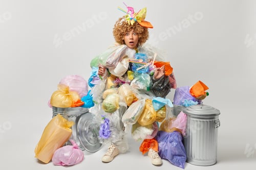 Preview: Shocked woman covered with plastic garbage saves environment from pollution collects plastic litter
