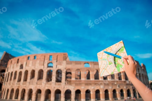 Preview: Closeup touristic map and toy airplane on Colosseum background. Italian european vacation in Rome