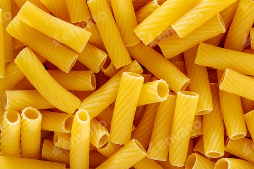 Preview: Tortiglioni type of whole wheat pasta with deep grooves which spiral around pasta, top view close-up