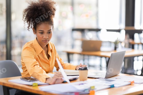 Preview: Attractive african young confident businesswoman Accounting using calculating income-expenditure and