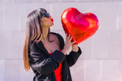 Preview: Girl with a heart balloon on Valentine's day, sunglasses and red dress
