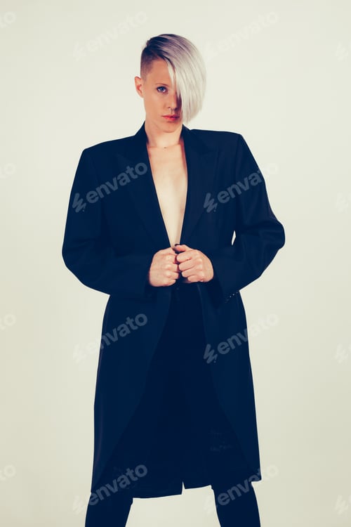 Preview: Portrait of a young woman with dark tailcoat and without shirt, shot in studio