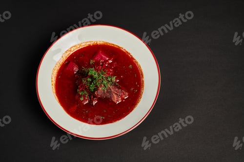 Preview: eastern European meal, traditional Ukrainian borsch with beef in ceramic bowl on black backdrop