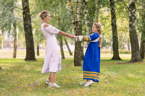 Preview: Caucasian mom and daughter are hugging while walking in nature. Mother and girl dancing