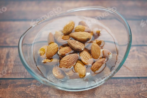 Preview: Close up of almond nuts in a bowl of water