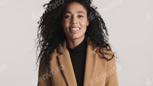 Preview: African American woman smiling on camera looking happy over white background