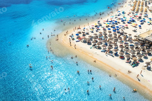 Preview: Aerial view of colorful umbrellas on beach, people in blue sea