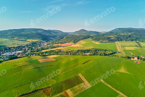 Preview: Mountain village and agricultural fields, aerial view. Nature landscape