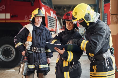 Preview: With notepad. Group of firefighters in protective uniform that is on station