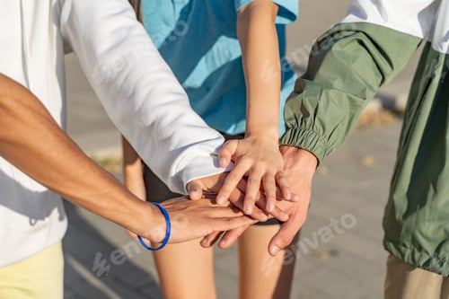 Preview: Student teamwork stacking diverse hands together. Multicultural group.