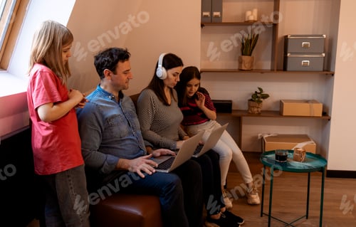 Preview: Happy digital tech caucasian family using electronic gadgets, holding laptop computer