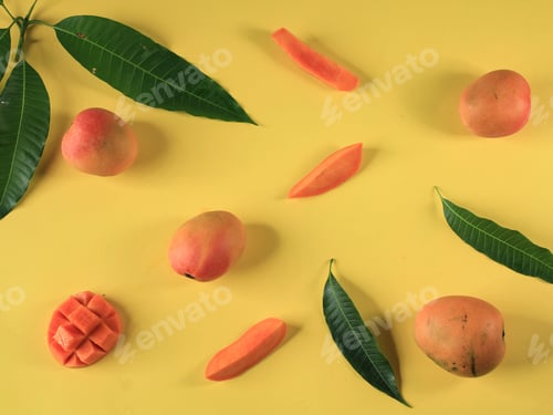 Preview: Yellow Background Concept of Ripe mango with Fresh Mango Leaf.