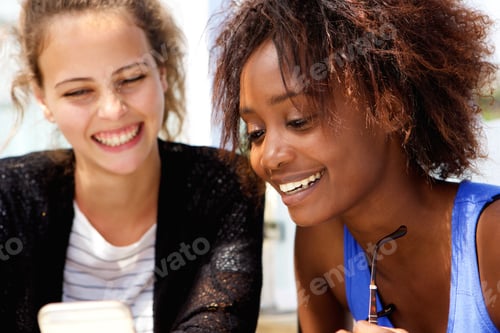 Two friends looking at mobile phone