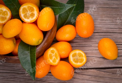 Preview: Top view of bunch of fresh kumquats in the organic food market.