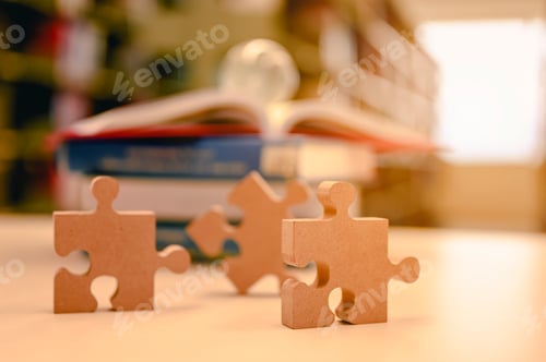 Preview: Businessman hands connecting jigsaw puzzle in the library background blur, Success and strategy.