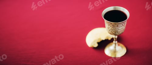 Preview: Unleavened bread, chalice of wine, silver kiddush wine cup on red background. Communion still life
