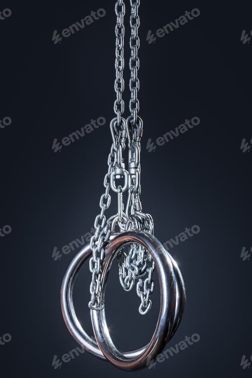 Preview: Closeup of metallic gymnastic rings on dark background
