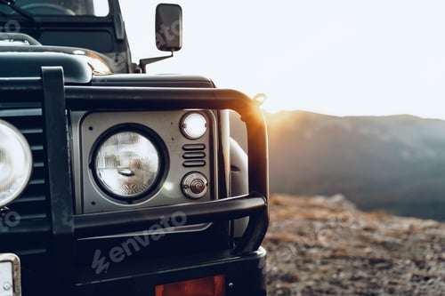 Preview: Dark green off-road car in the mountains