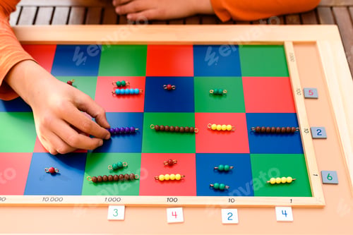 Preview: Student boy using a montessori checker board outdoors doing homeschooling.