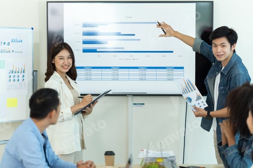 Preview: Business people showing team work while working in board room in office interior.