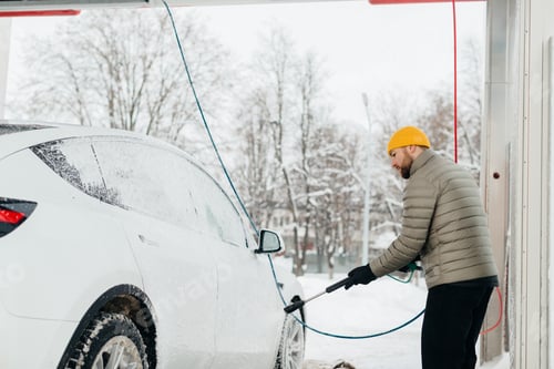 Preview: Man washing electric car at self service car wash