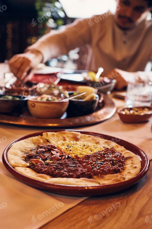 Preview: Close-up of Turkish pizza on dining table.