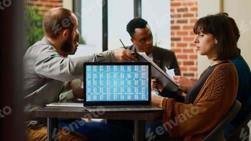 Preview: Business colleagues wokring with real time stock market