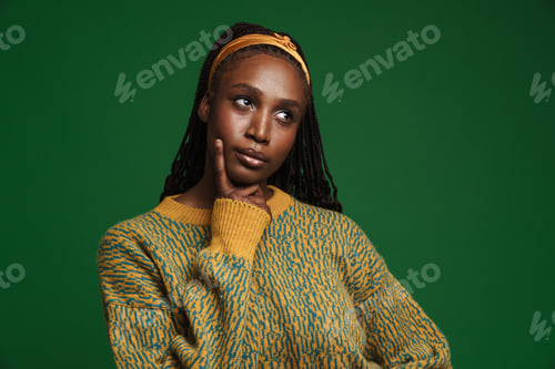 Preview: Black young woman with pigtails posing and looking aside