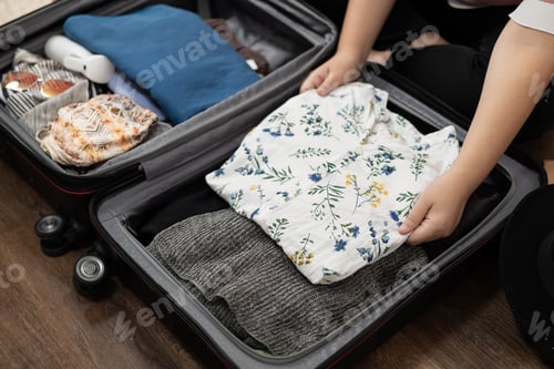 Preview: Woman packs baggage in suitcase for new journey packing a luggage travel plans vacation