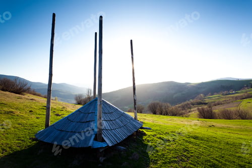 Preview: Green field with heaps of hay in village