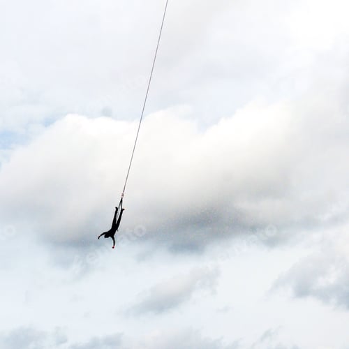 Person Bungee Jumping in Cloudy Sky