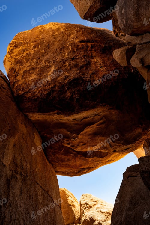 Preview: Close-up of a large rock formation against a clear blue sky