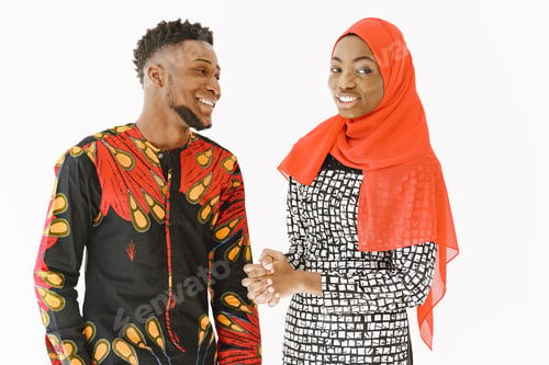 Preview: African students in traditional clothes with book in white studio
