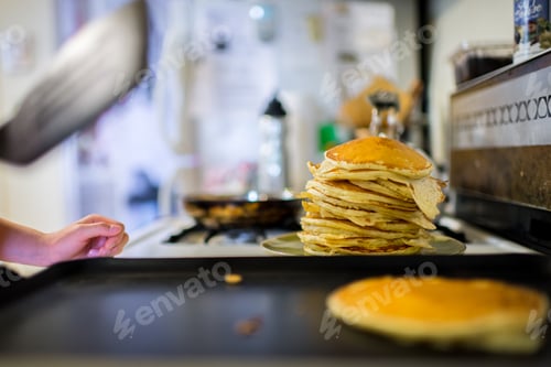 Preview: Young asian girl making buttermilk pancakes