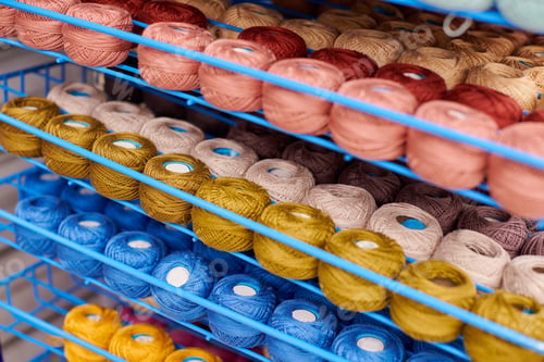 Preview: Yarns or balls of wool on shelves in store for knitting