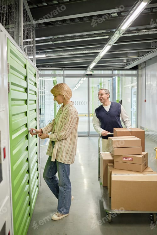 Preview: Middle Aged Woman Opening Locker While Caucasian Man Waiting